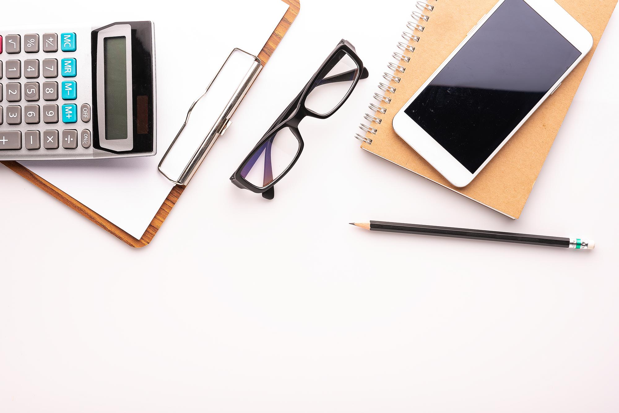 Notebook and calculator on table